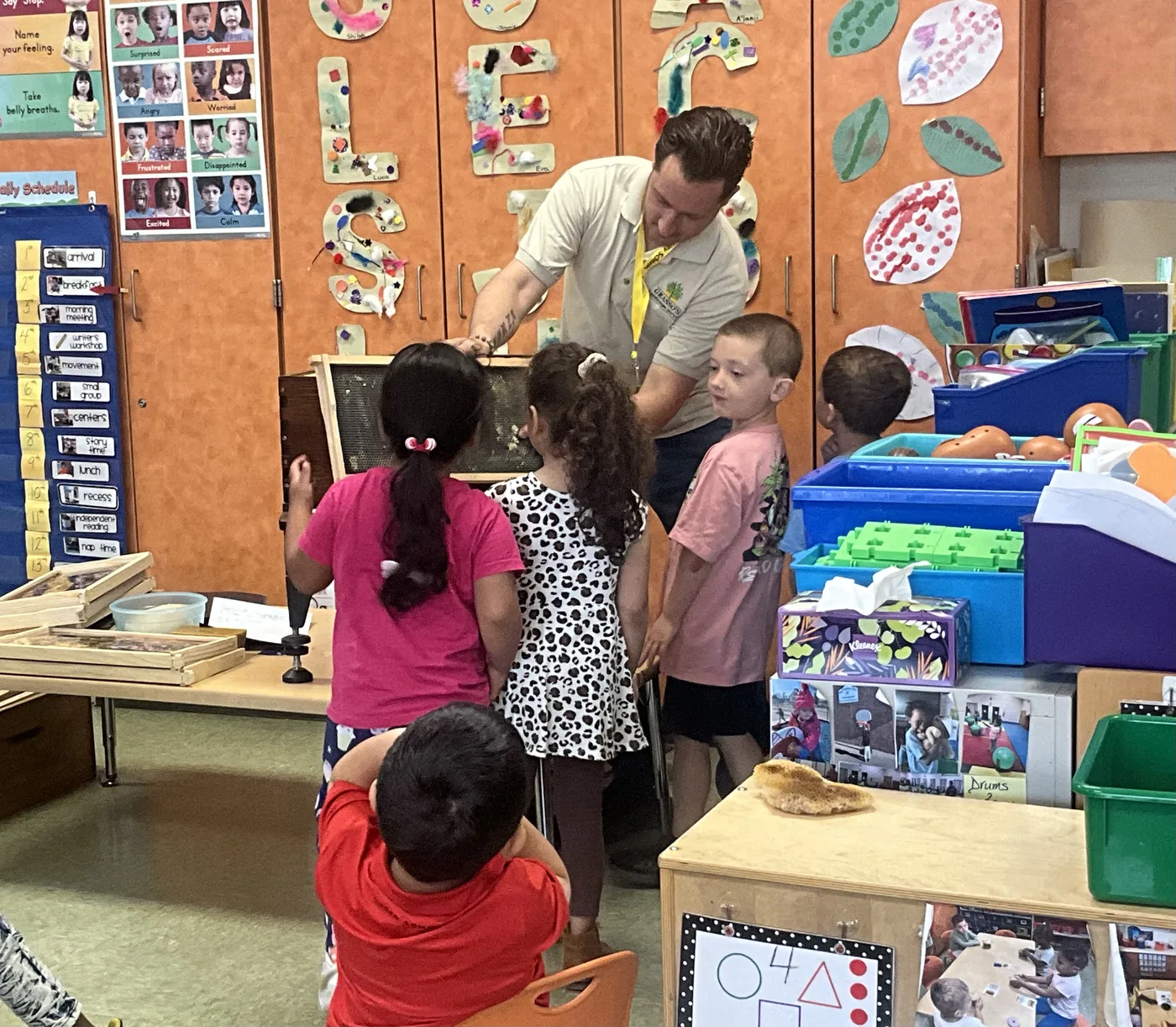 Founder Don Grasso shows a honeycomb frame to students at Egg Harbor City Elementary